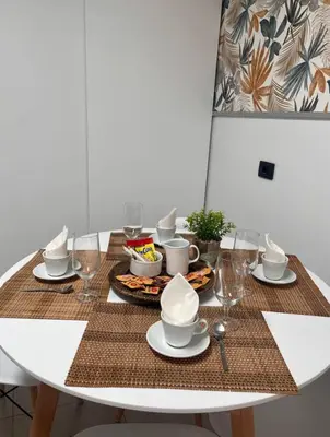 a dining room table with plates and glasses on it at La casa de Elena con terraza en el centro in Lugo