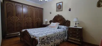 a bedroom with a large wooden bed and a dresser at Casa SANTALLA in O Barco de Valdeorras