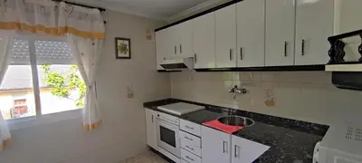 a kitchen with white cabinets and a sink and a window at Casa SANTALLA in O Barco de Valdeorras