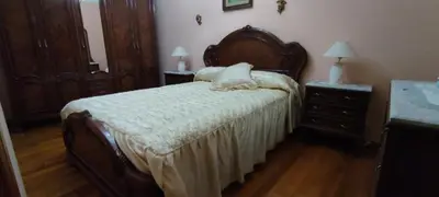 a bedroom with a bed and two night stands with lamps at Casa SANTALLA in O Barco de Valdeorras