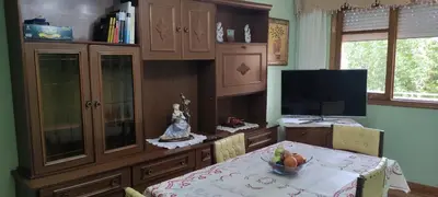 a dining room with a table and a television at Casa SANTALLA in O Barco de Valdeorras