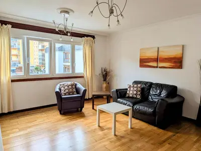 a living room with a couch and two chairs at Foz Beach Home in Foz