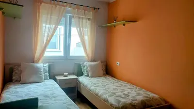 a bedroom with two beds and a window at Foz Beach Home in Foz