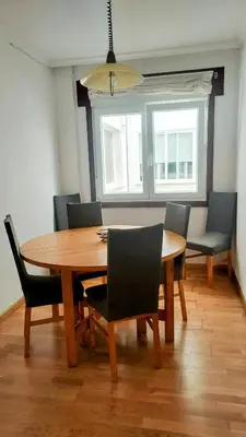 a dining room with a wooden table and chairs at Foz Beach Home in Foz