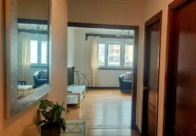 a hallway with a living room with a mirror at Foz Beach Home in Foz