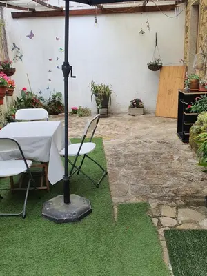 a table and chairs with an umbrella in a garden at Medieval Gem in Santiago de Compostela
