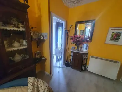 a room with a bedroom with yellow walls and a mirror at Medieval Gem in Santiago de Compostela
