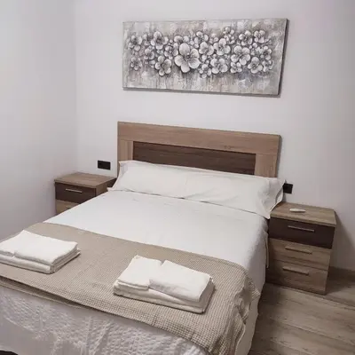 a bedroom with a bed with two towels on it at O Lar da Crega in O Pino