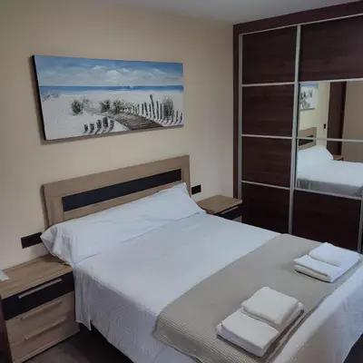 a bedroom with a bed with two towels on it at O Lar da Crega in O Pino