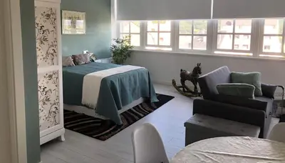 a bedroom with a bed and a couch and a chair at Estudios rúa Maior, 49-2B in Sarria