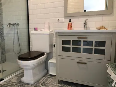 a bathroom with a toilet with a sink and a shower at Estudios rúa Maior, 49-2B in Sarria