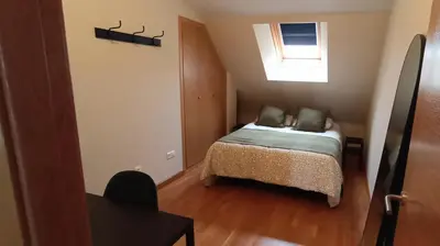 a small bedroom with a bed and a window at AYE Catedrales in Barreiros