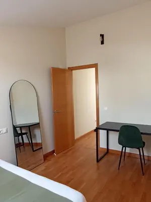 a bedroom with a table and a mirror and a door at AYE Catedrales in Barreiros