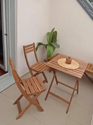 a table and a chair and a table and a plant at AYE Catedrales in Barreiros