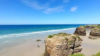 a view of a beach with rocks and the ocean at AYE Catedrales in Barreiros