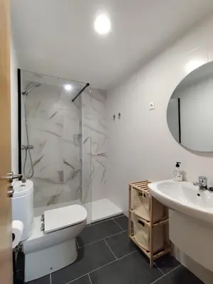 a bathroom with a toilet and a sink and a shower at AYE Catedrales in Barreiros