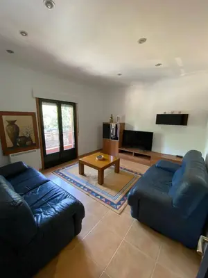 a living room with two blue couches and a table at Carballeira in Moraña