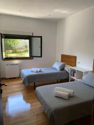 a room with two beds and a window at Carballeira in Moraña