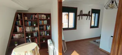 a room with book shelves filled with books at As Lamelas in Cea