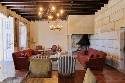 a living room with chairs and a fireplace at Casa Palacio Ribeira Sacra in Esgos