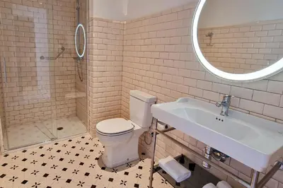 a bathroom with a toilet and a sink and a mirror at Casa Palacio Ribeira Sacra in Esgos