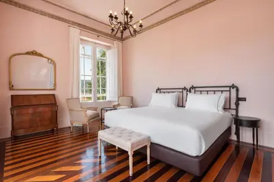 a bedroom with a large bed and a mirror at Casa Palacio Ribeira Sacra in Esgos