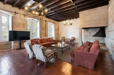 a living room with couches and a flat screen tv at Casa Palacio Ribeira Sacra in Esgos