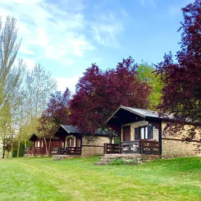 a stone house with trees in front of it at Casa Rural Santa Mariña in Portomarin