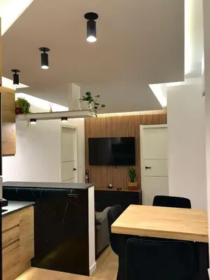 a kitchen with a table and a tv in a room at Kilometro 22 Luxury in Padrón