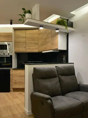 a living room with a couch and a kitchen at Kilometro 22 Luxury in Padrón