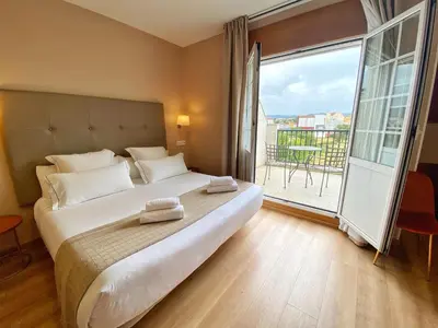 a bedroom with a large bed and a large window at Hotel Ribeira Sacra in Monforte de Lemos