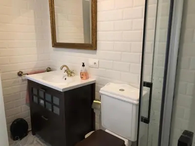 a bathroom with a sink and a toilet and a mirror at Estudios rúa Maior, 49-2A in Sarria