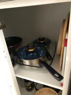 a shelf with two pots and pans in a kitchen at Estudios rúa Maior, 49-2A in Sarria