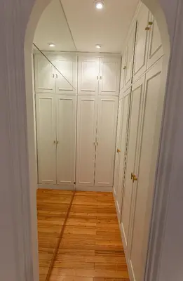 an empty room with white cabinets and wood floors at Travesa in Betanzos