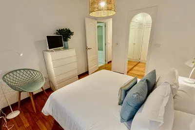 a bedroom with a bed and a television and a chair at Travesa in Betanzos