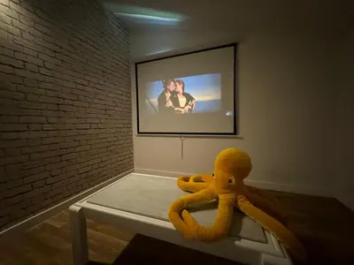 a yellow stuffed octopus sitting on a table in a room at Chalet Abelleira Playa Barreiros in Barreiros
