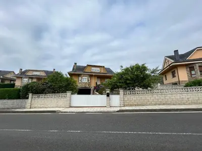 a fence on the side of a street with houses at Estupenda casa cercana a la playa y a la montaña VUT6678AS in La Caridad