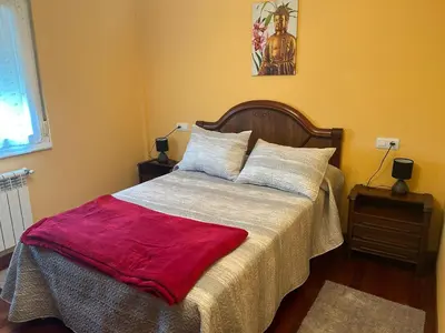 a bedroom with a bed with a red blanket on it at Estupenda casa cercana a la playa y a la montaña VUT6678AS in La Caridad