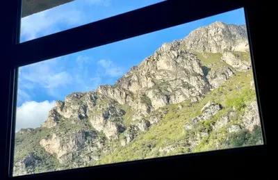 a view of a mountain from a window at Roca de Guía Somiedo in Pola de Somiedo