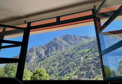 a view of a mountain from a bus window at Roca de Guía Somiedo in Pola de Somiedo