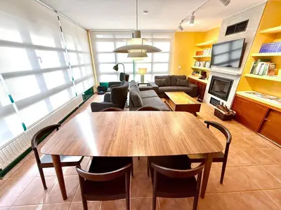 a living room with a table and a couch at Roca de Guía Somiedo in Pola de Somiedo