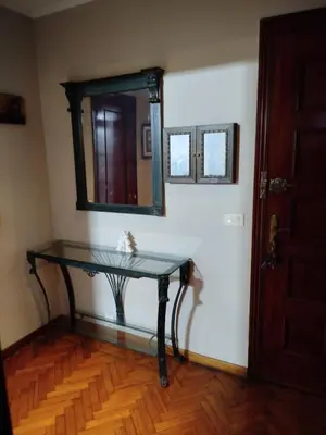 a glass table with a mirror on a wall at Ático Milladoiro in Milladoiro