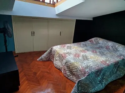 a bedroom with a bed and cabinets in it at Ático Milladoiro in Milladoiro