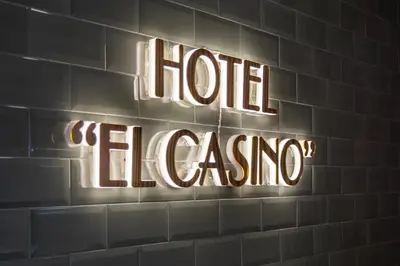 a neon sign on a brick wall with the words hog emergency at Hotel & Restaurante El Casino in Villafranca del Bierzo