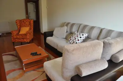 a living room with a couch and a chair at Katxutxa El corazon de Galicia in Lalín