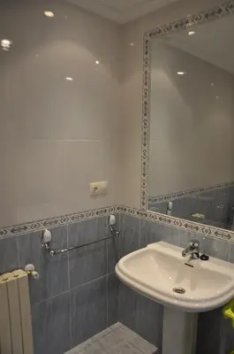 a bathroom with a sink and a mirror at Katxutxa El corazon de Galicia in Lalín