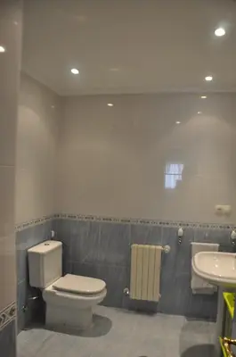 a bathroom with a toilet and a sink at Katxutxa El corazon de Galicia in Lalín