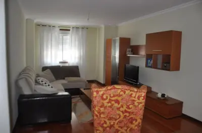 a living room with a couch and a chair at Katxutxa El corazon de Galicia in Lalín