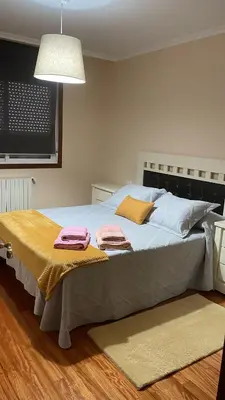 a bedroom with a bed with two towels on it at Katxutxa El corazon de Galicia in Lalín