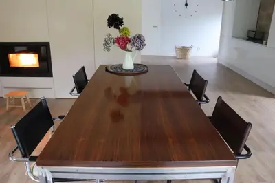 a table with chairs and a vase with flowers on it at Luxury Pombar in Ourense